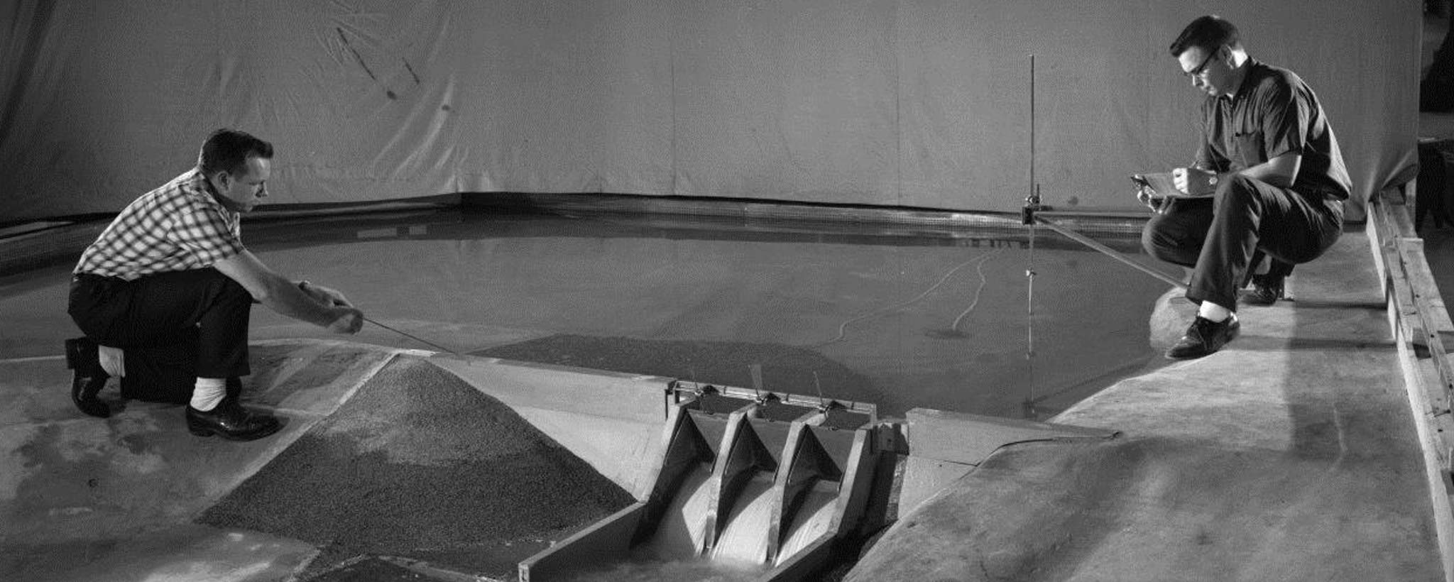 engineers and model of dam
