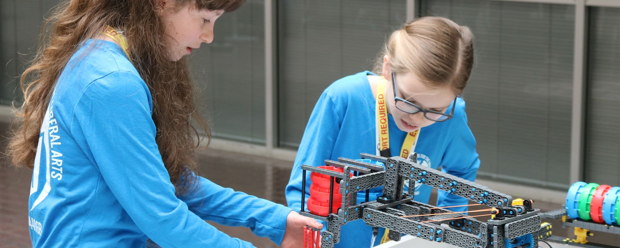 Girls building a robot in a STEM classroom