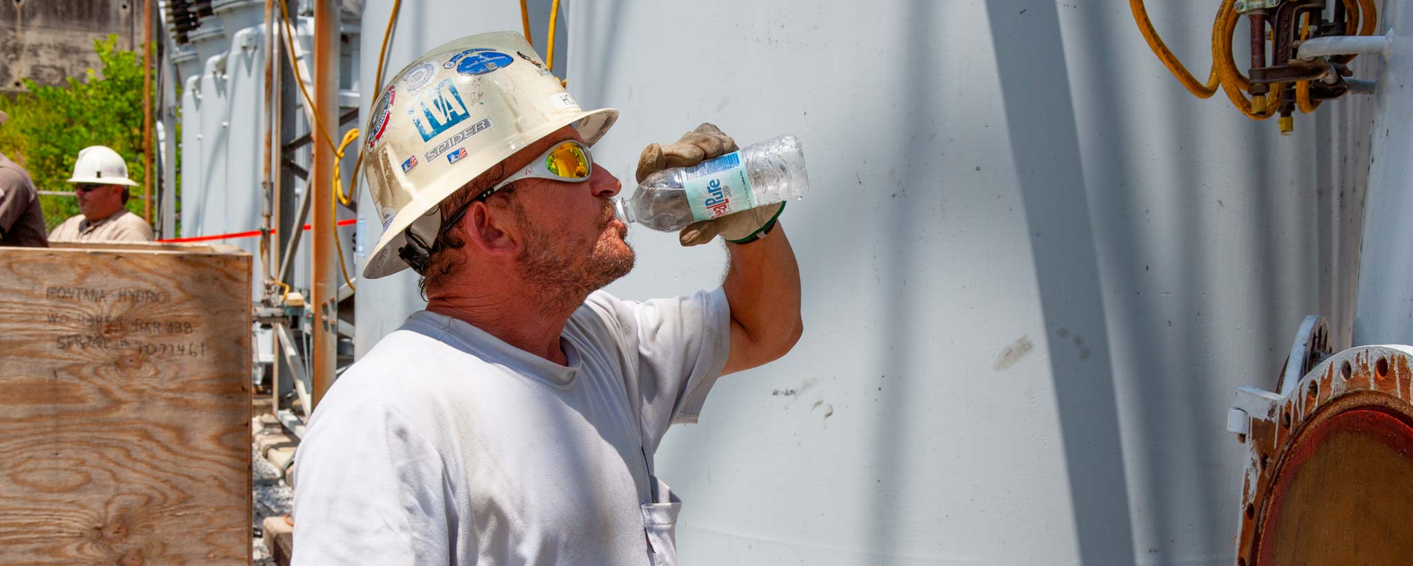 Electrician drinking water on a hot summer day