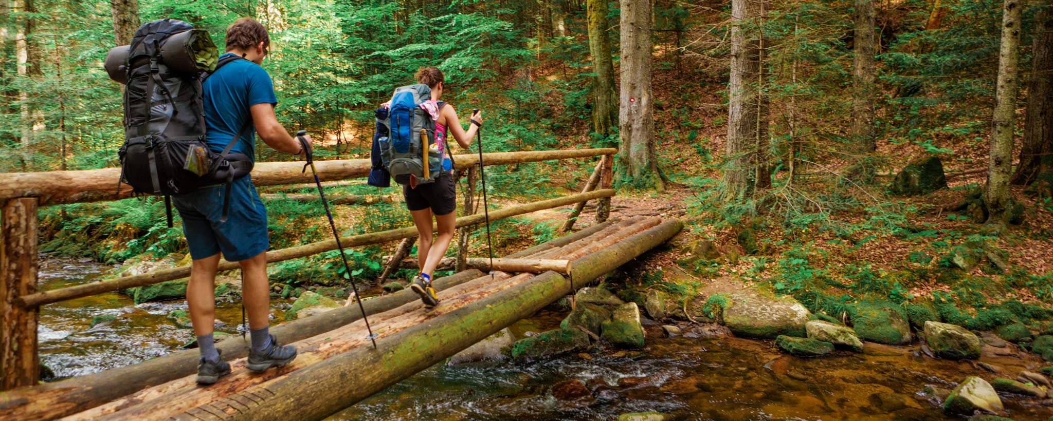 hikers  crossing footbridge