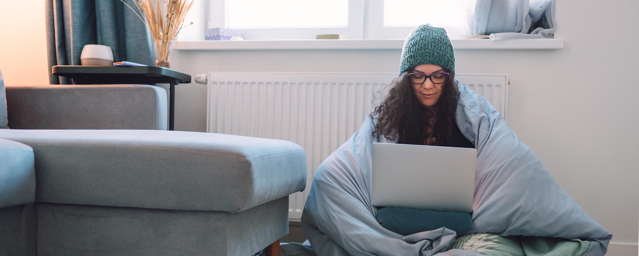 Woman on laptop staying warm