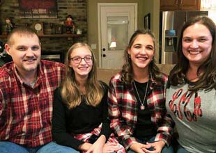 Mobley is pictured with daughters and wife Laura.