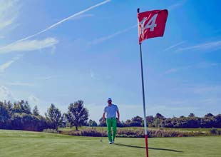 Golfer playing golf, near 14th hole