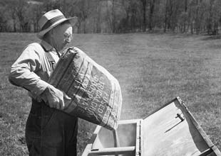 Farmer filling fertilizer a box