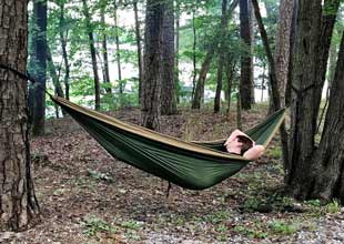 A Boy in laying in a  hammock