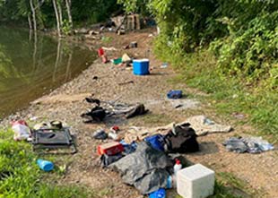 Dirty Campsite with scattered garbage waste in Camping