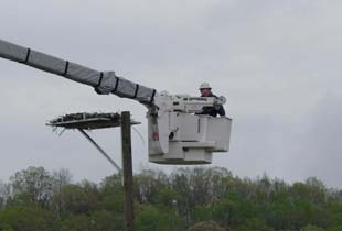 Lineman in a bucket catching osprey