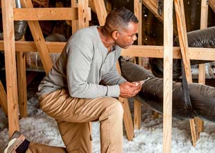 Man weather proofing his home