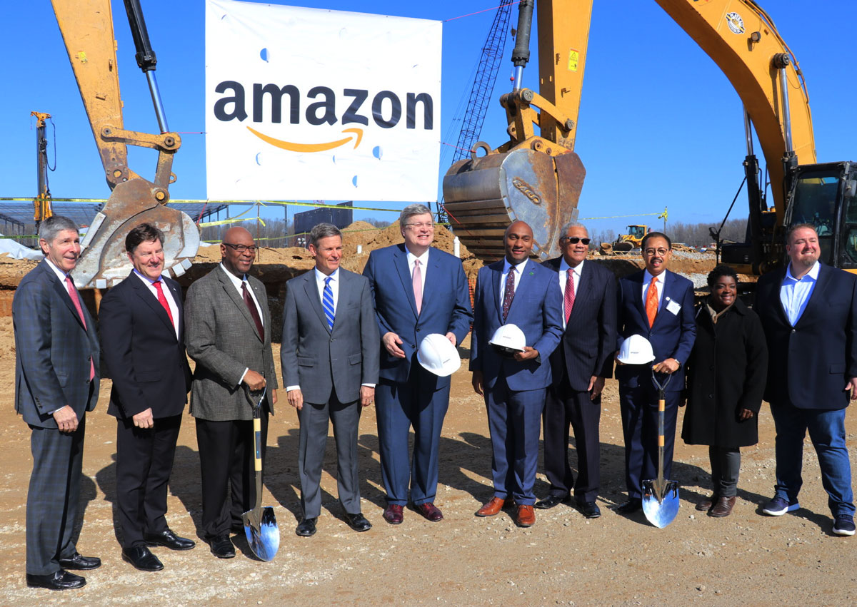 Group of people standing in front of construction equipment