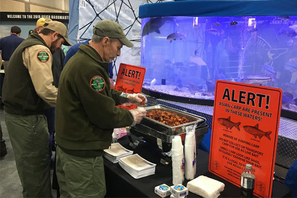 Man getting fried silver carp at TVA's booth