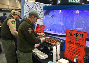 Man getting fried silver carp at TVA's booth