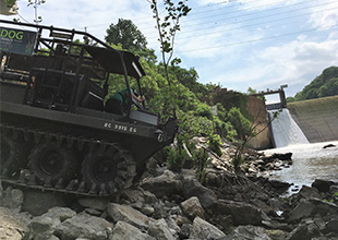 High-tech amphibious vehicle loaded with Dam Safety sonar equipment accessing the toe of the dam