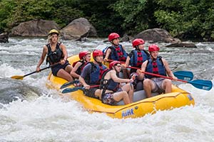 Group of people white water rafting