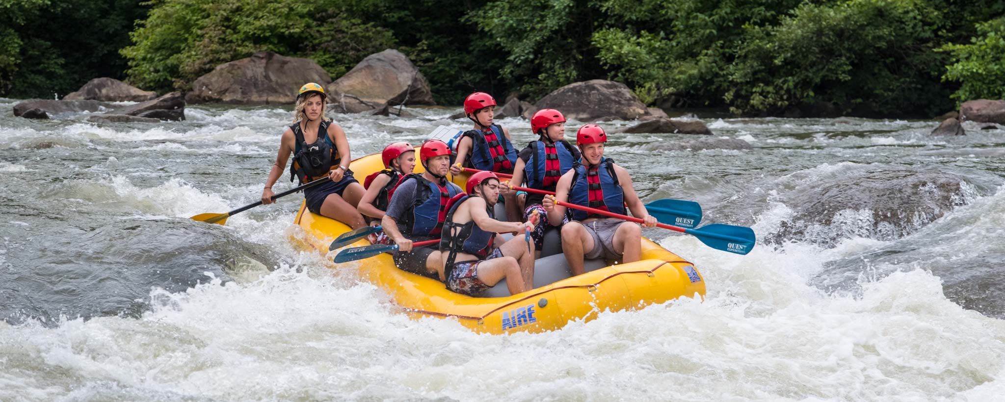 Group of people white water rafting