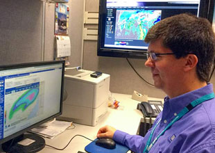 Jeff House meteorologist at his desk