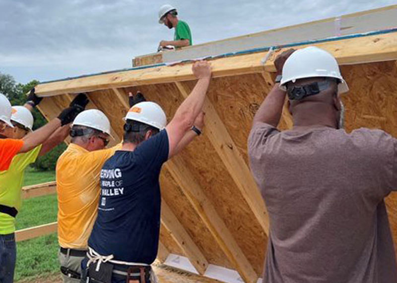 workers standing a wall up