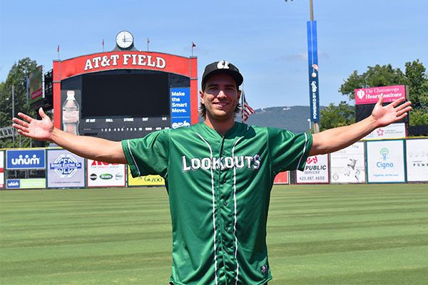 A baseball player is wearing a Lookouts shirt