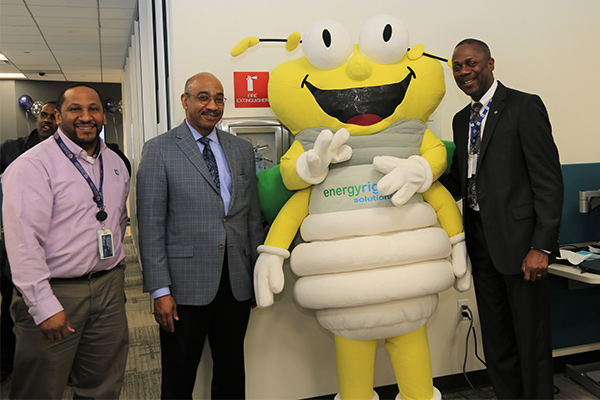 Sam Caviness, Alonzo Weaver and  Mark Creech pose with Louie the Lightning Bug