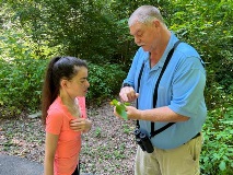 Damien Simbeck discussing native plant with participant