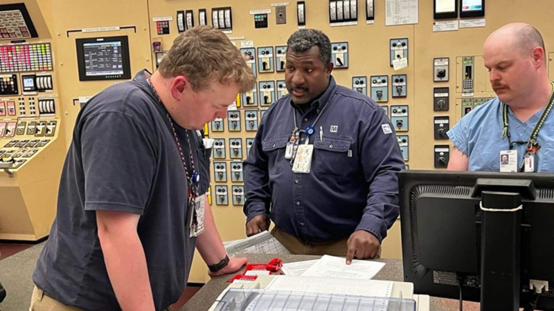 TVA employees discussing plans at plant