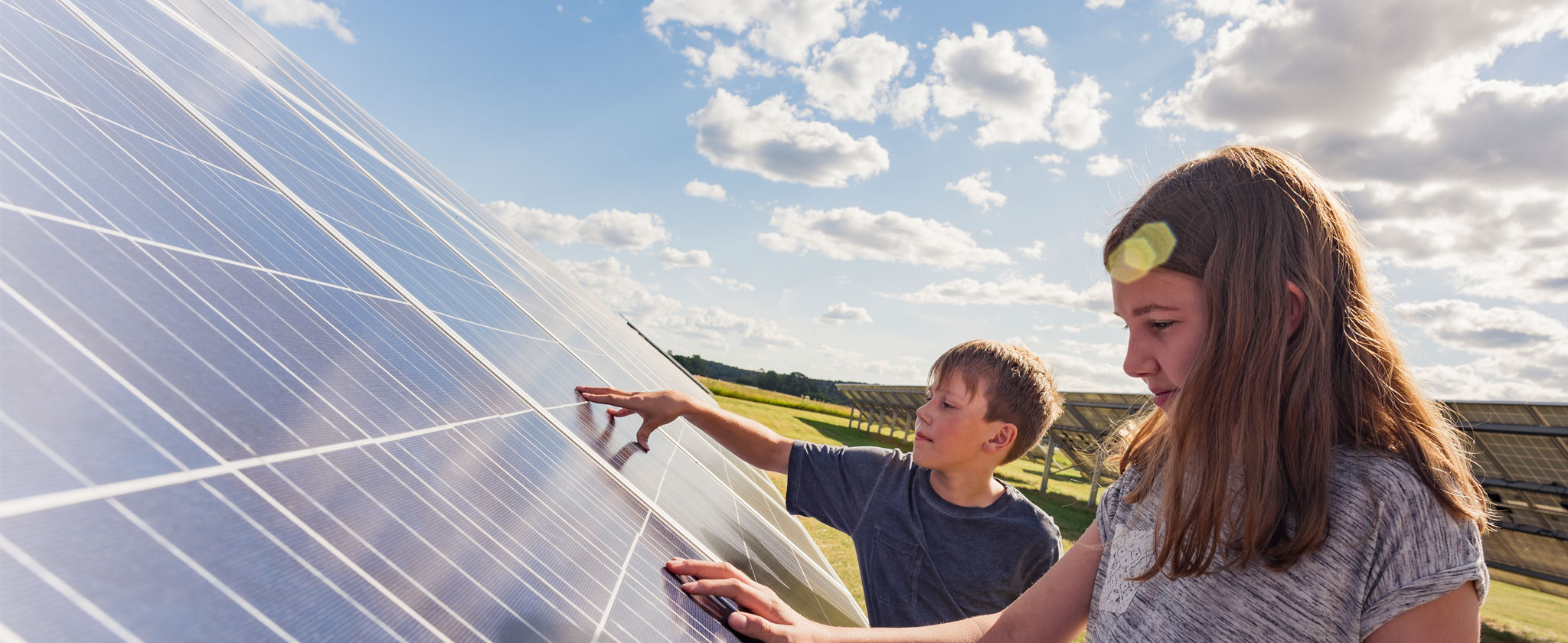 Kids touching solar panel