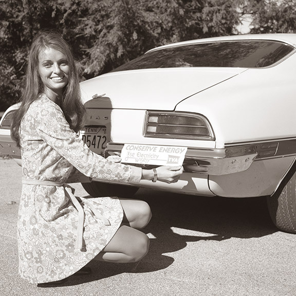 Woman in front of a car